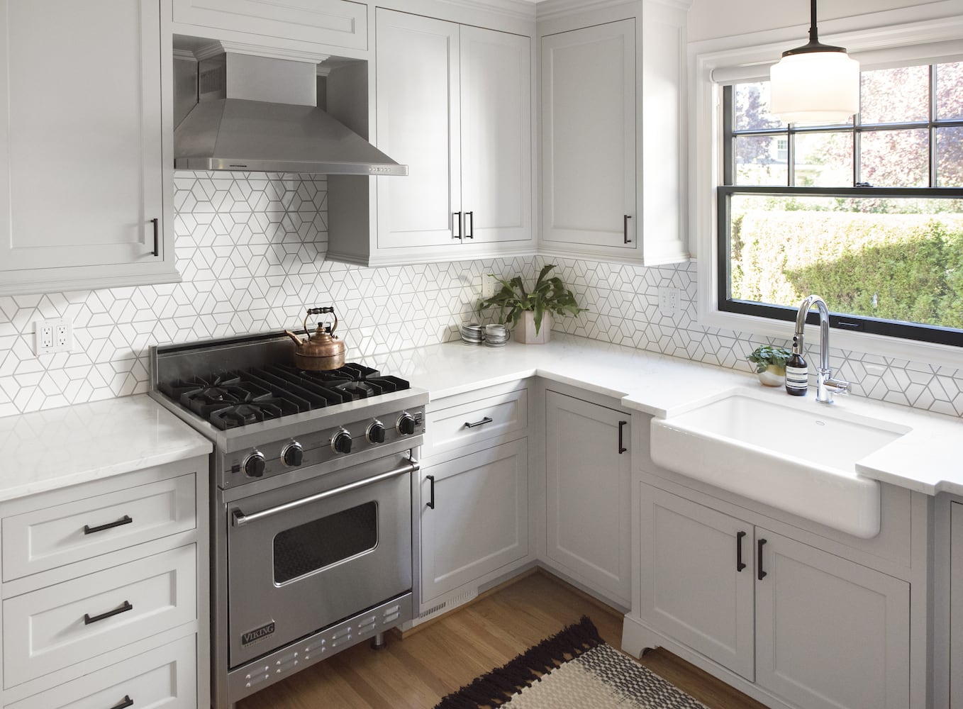 Bright Portland kitchen remodel with white apron sink, white counters and cabinets