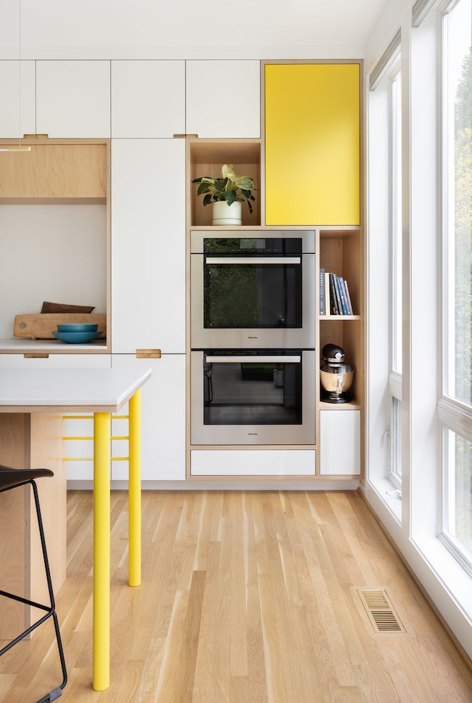 Kitchen remodel corner with Stainless steel double Miele wall ovens, yellow highlights