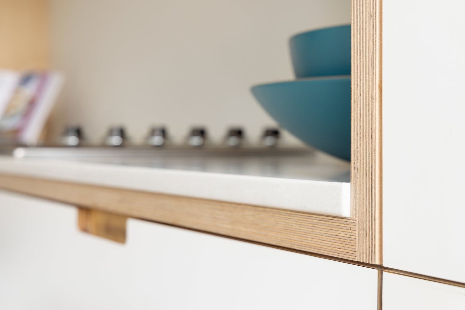 Detail of expertly coordinated corner angle with cabinetry, countertop, drawers aligned