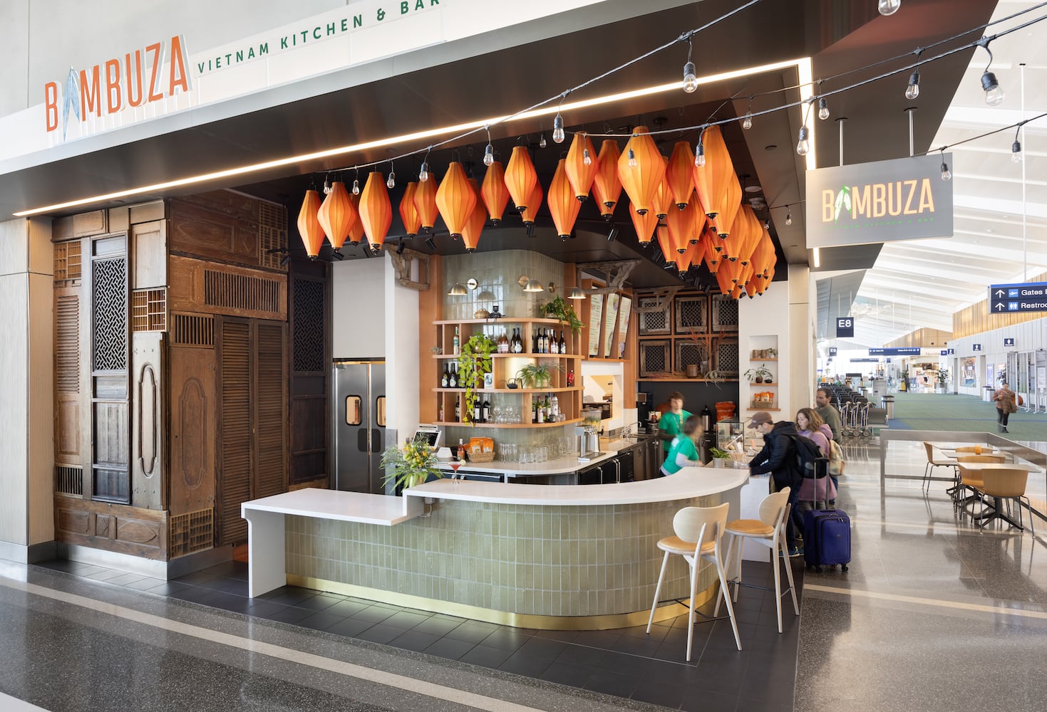 A wrap-around bar with light green tile and bright orange lights decorate PDX terminal