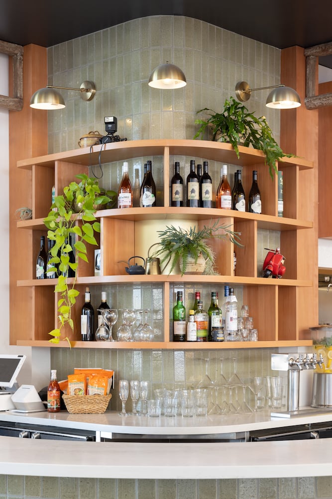 Custom designed shelving holds glassware, alcohol, plants and decorations
