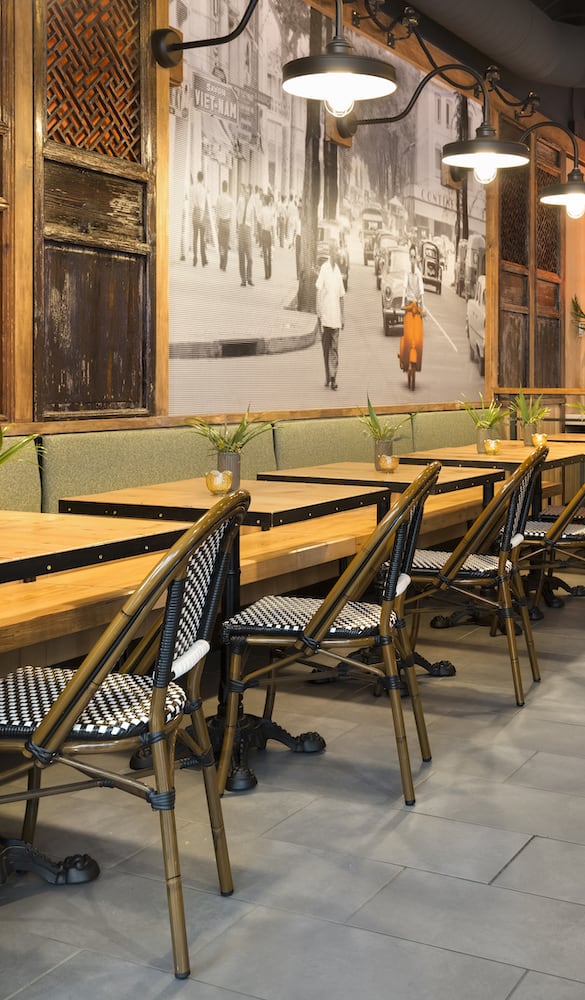 Row of wood tables in Seatac Bambuza, with bamboo seating and reclaimed wall dressings
