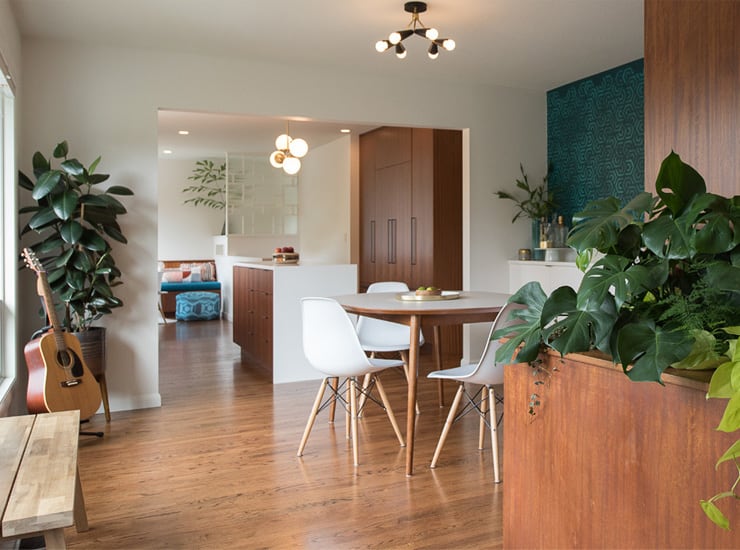 Midcentury kitchen and dining space with original wood floors, mahogany cabinets
