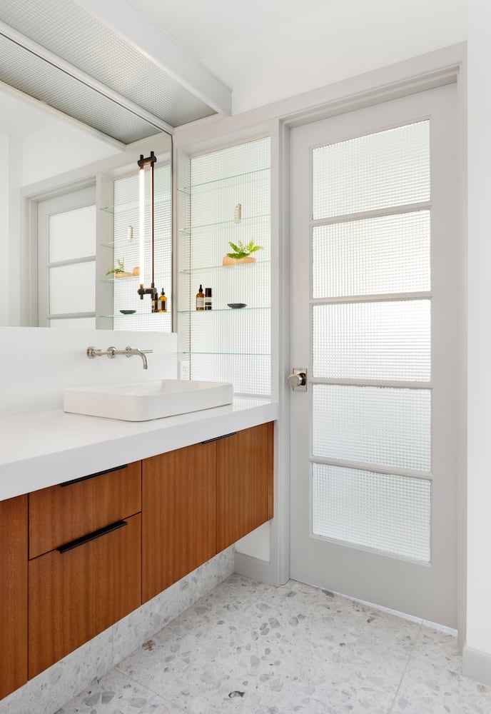 Bathroom with mahogany vanity, vessel sink, waffle glass, terrazzo tile