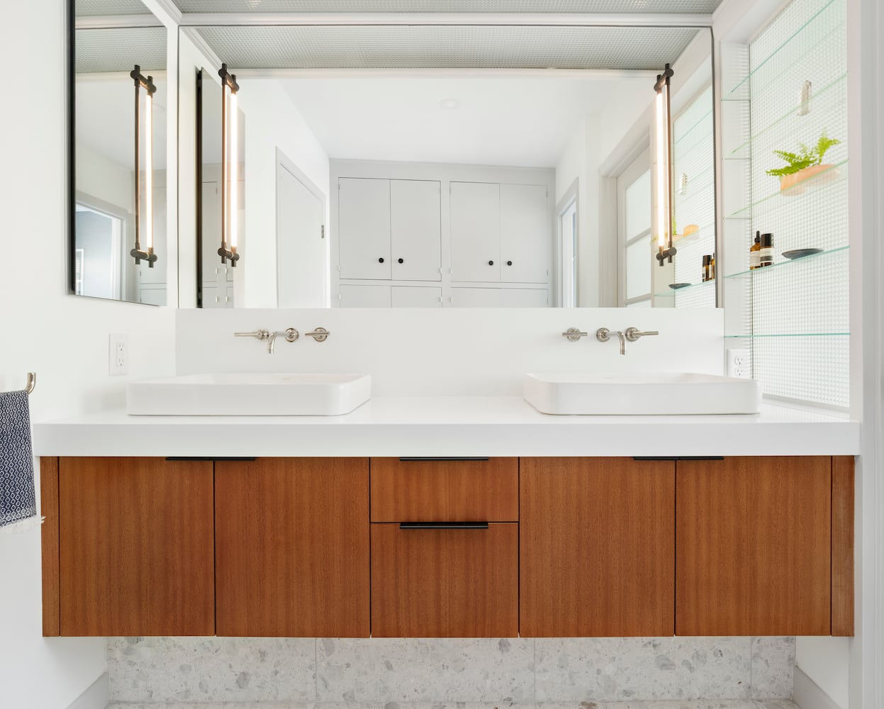 Bathroom with double vanity, vessel sinks, terrazzo tile, thin vanity lights