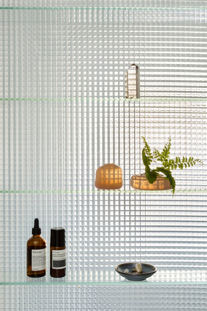 Detail of original bathroom glass shelves with waffle glass background