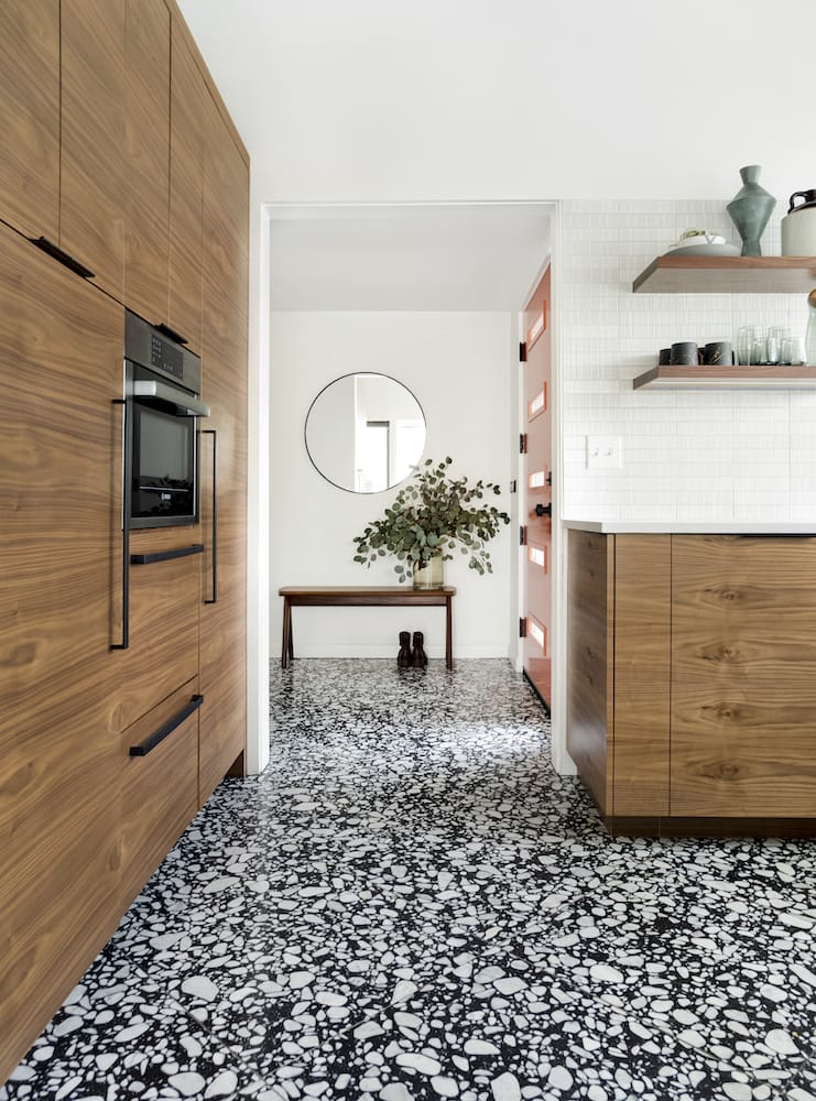Portland midcentury kitchen with terrazzo floor, walnut cabinets, panel fridge