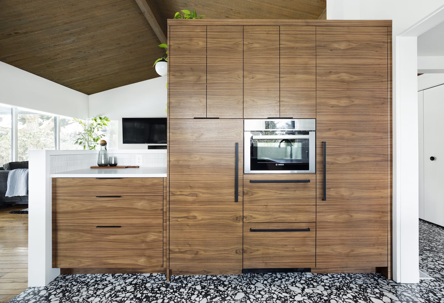 Remodeled kitchen with terrazzo floors, walnut cabinets, open floor plan