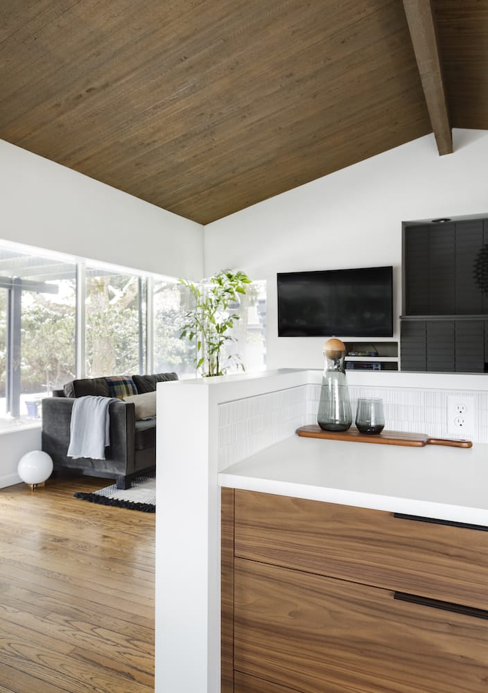 Vaulted exposed wood ceilings in midcentury kitchen remodel, white quartz counters