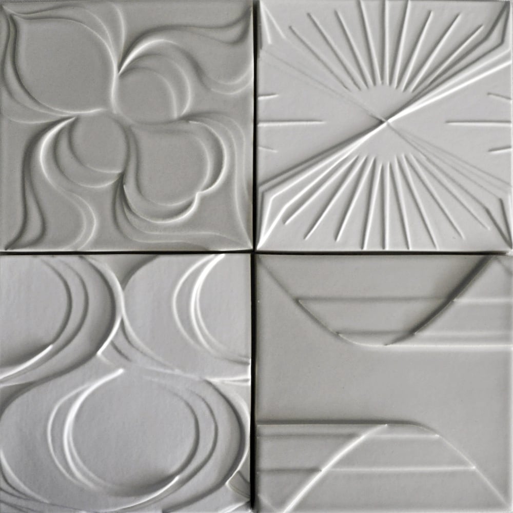 Detail of four square ceramic tiles each with different modern textured patterning