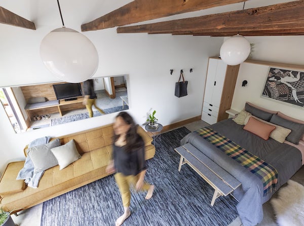 Portland ADU with exposed wood beams, concrete floors, bed and couch