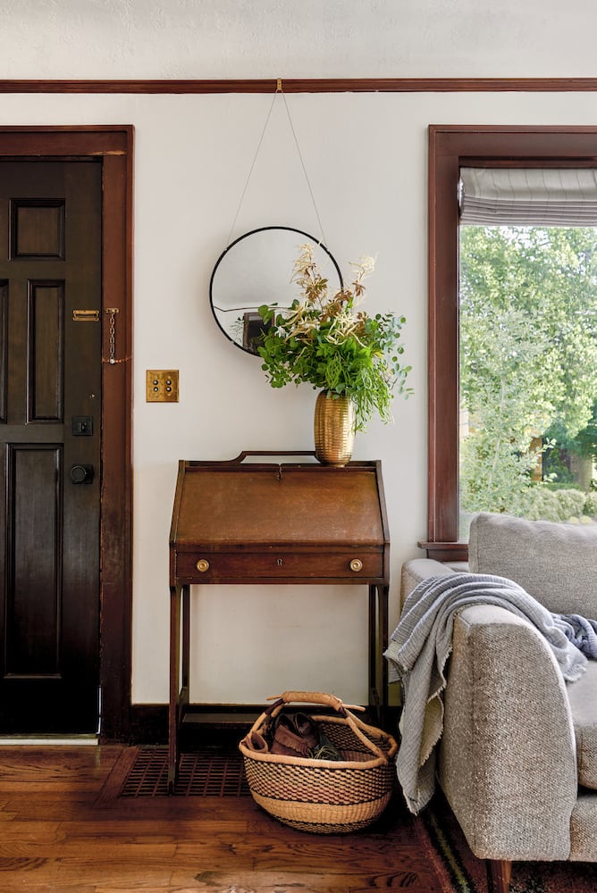 Living room front door, secretary desk, oak wood floors, vintage light switches