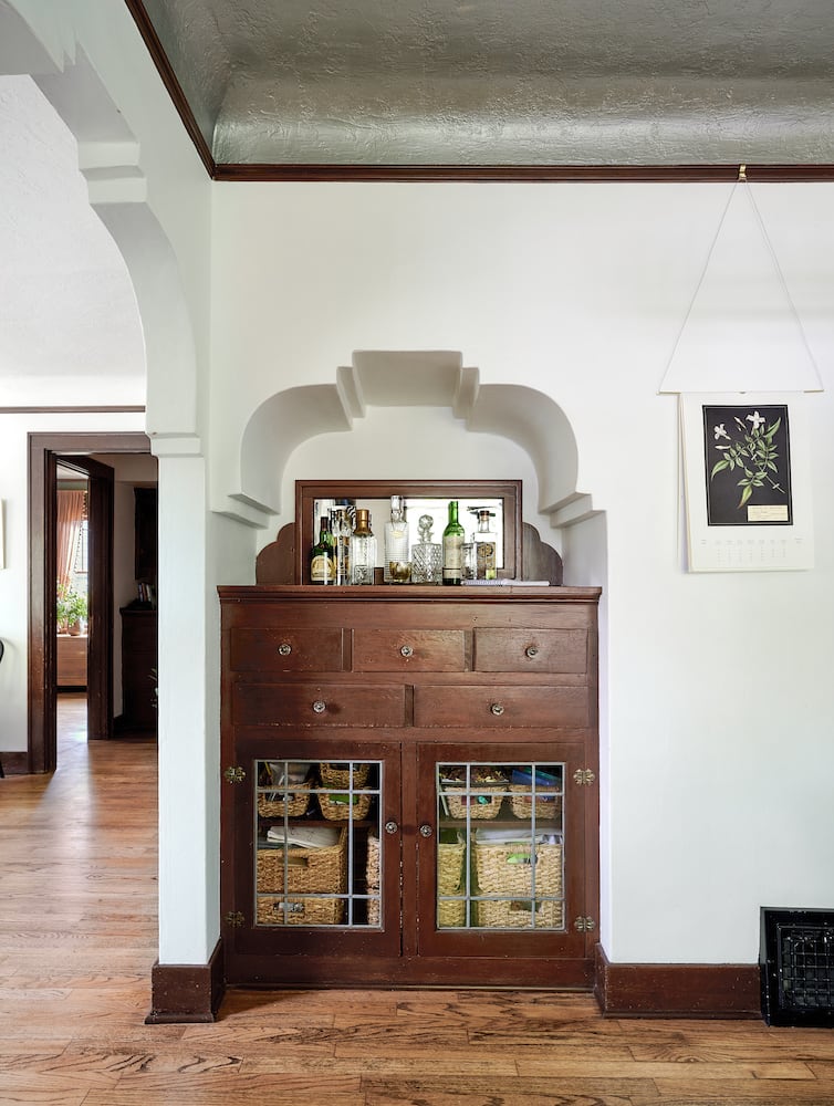 Original built-in bar with decorative arch, oak wood floors, picture rail