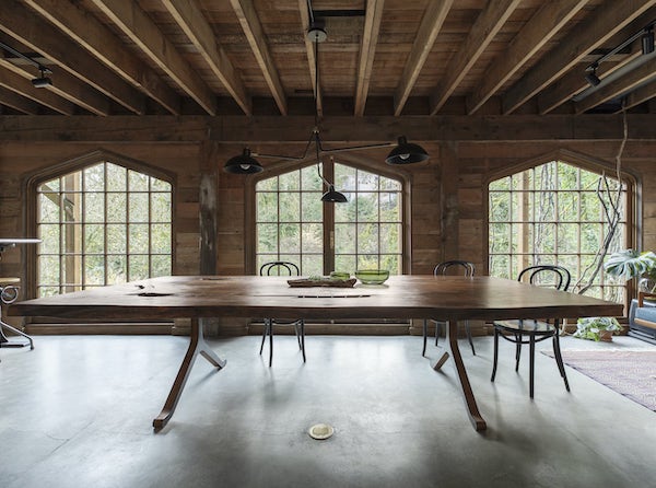 Huge open space Northwest remodel with large windows, concrete floors, live edge table
