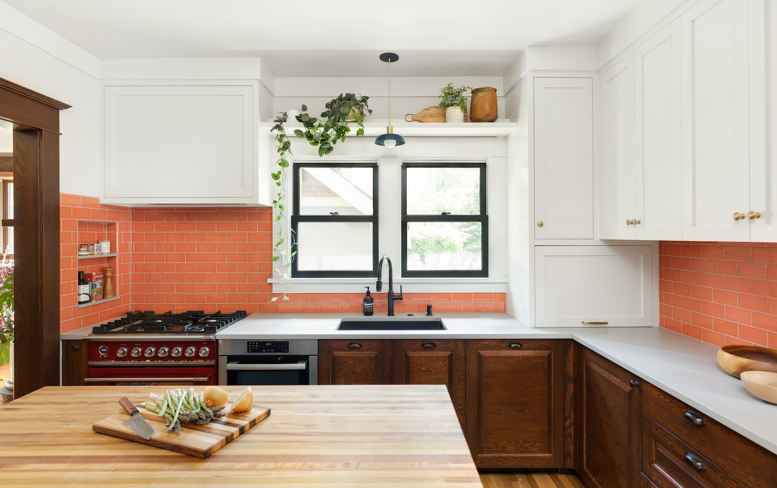 Eclectic, playfully refined Portland kitchen with orange tile and Caesarstone counters