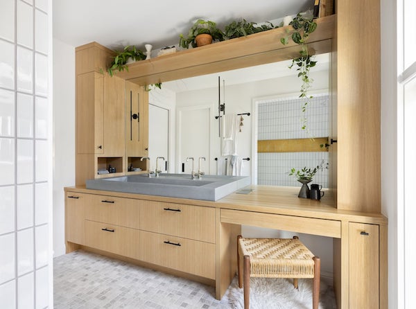 Custom bathroom with white oak cabinets, concrete/cement ramp sink, huge mirror