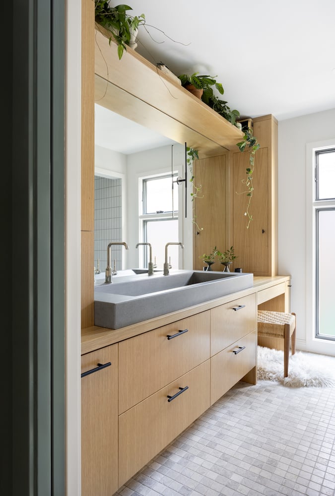 Angle into bathroom with cement sink, polished nickel faucets, Juniper floating sconces