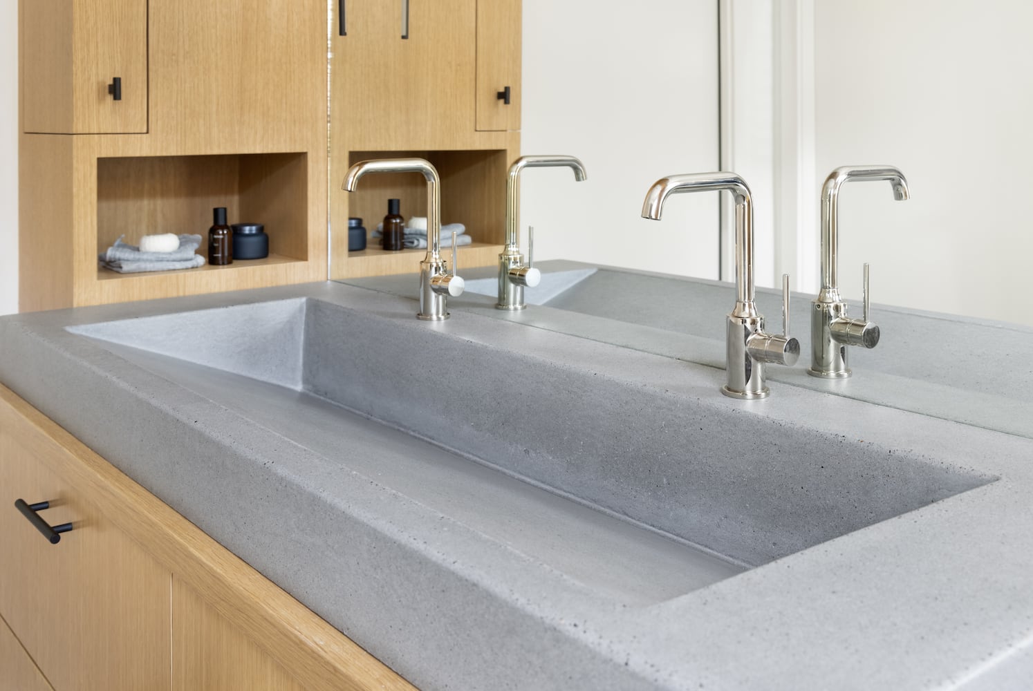 Detail of Cement Elegance concrete ramp sink with Crosswater London lavatory faucets