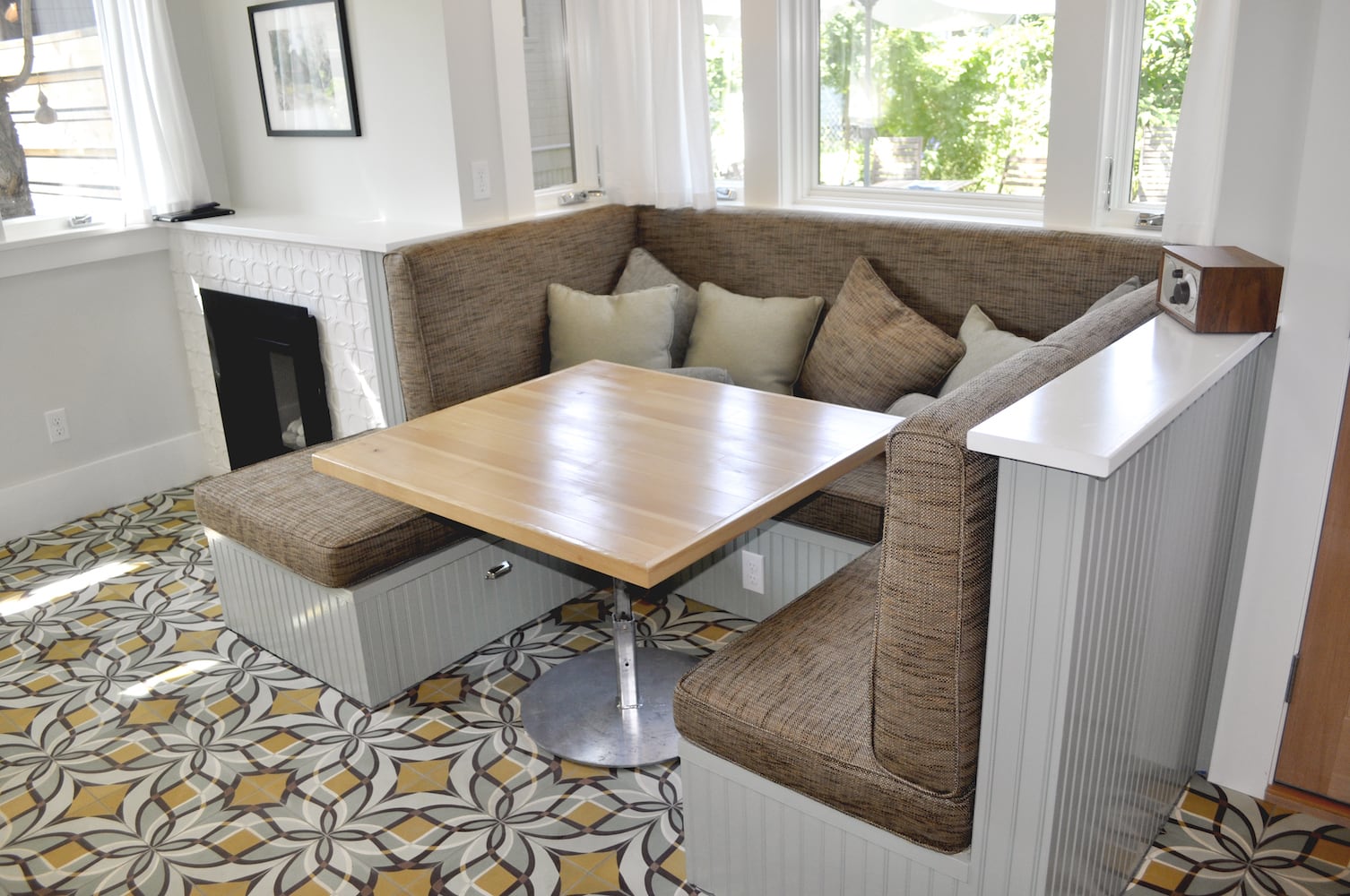 Built-in couch that becomes a dining nook when a small square table is added