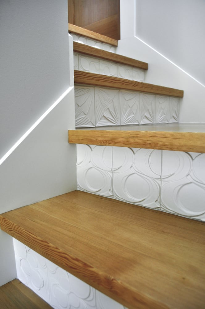 Humboldt ADU: Detail of stairway with wood steps and beautifully detailed modern white tile toe kick