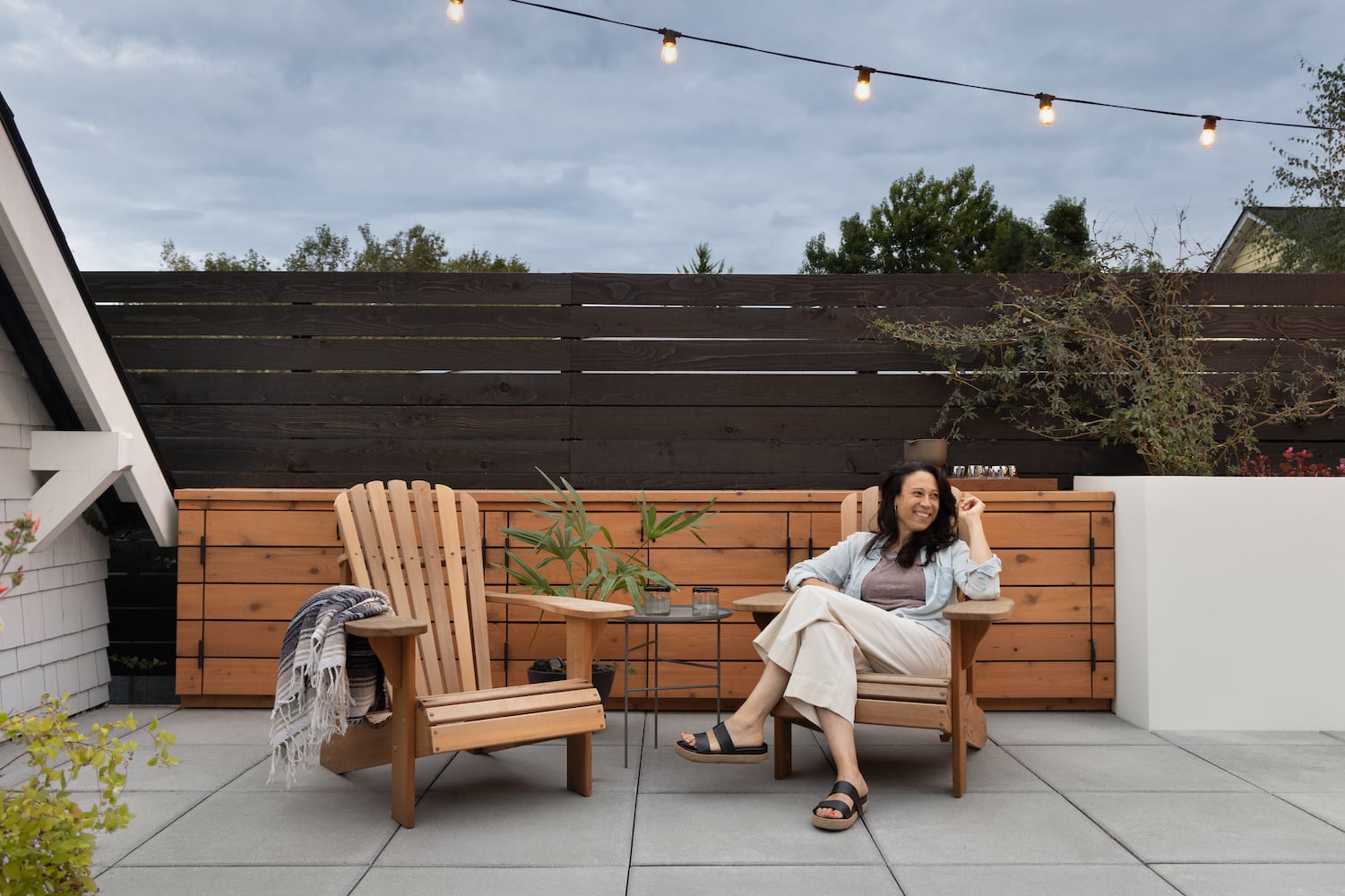 Interior designer Stephanie Dyer enjoying a backyard Portland patio she helped design