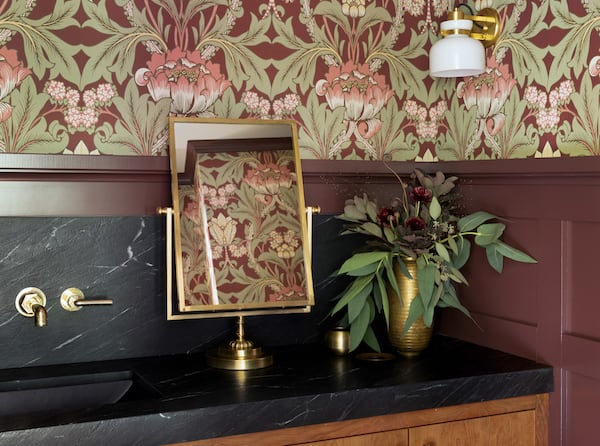 Modern bathroom renovation with burgundy wainscot, dark granite counters