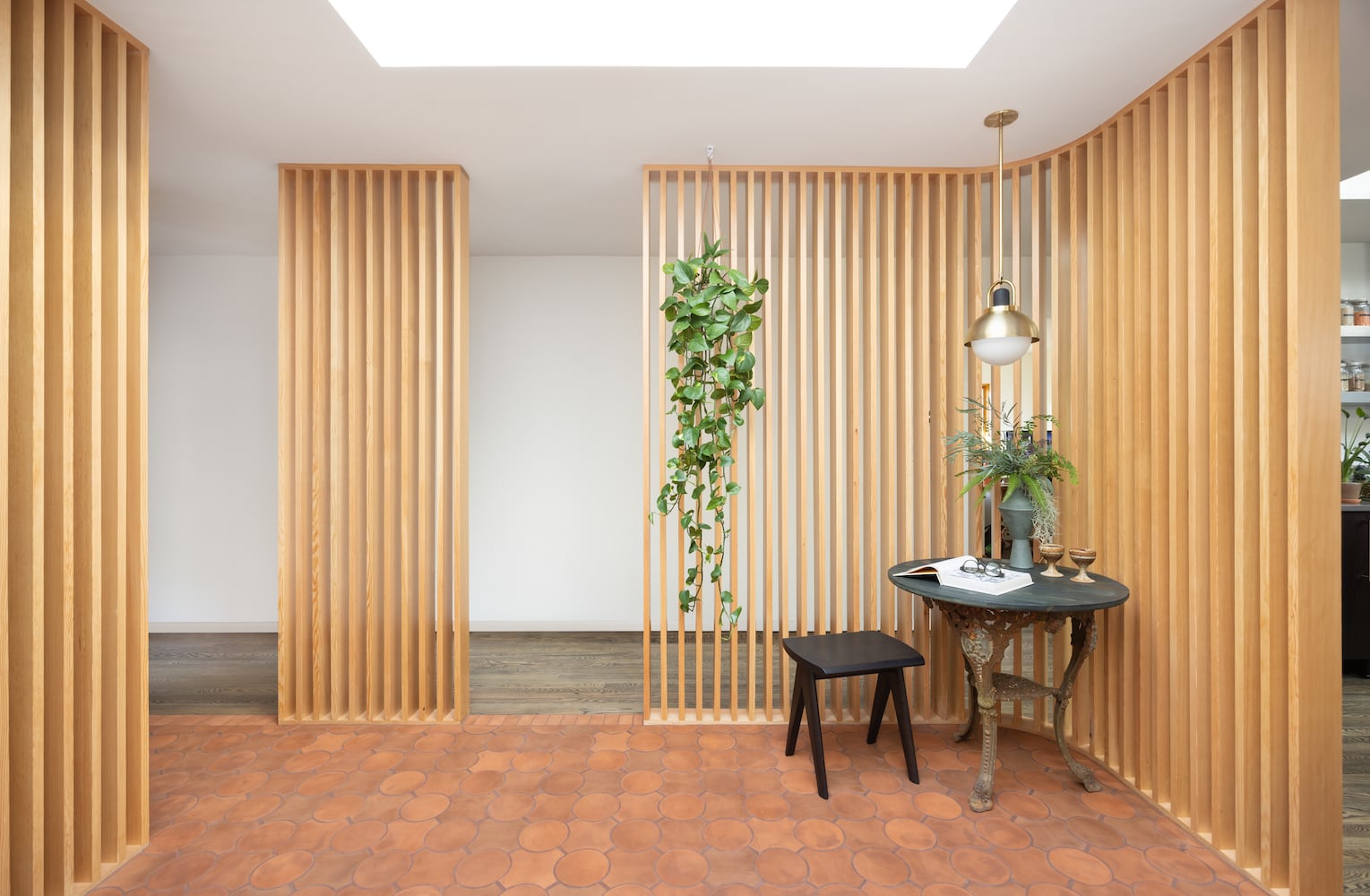Vertical wood slats surround this one of a kind bathroom atrium design