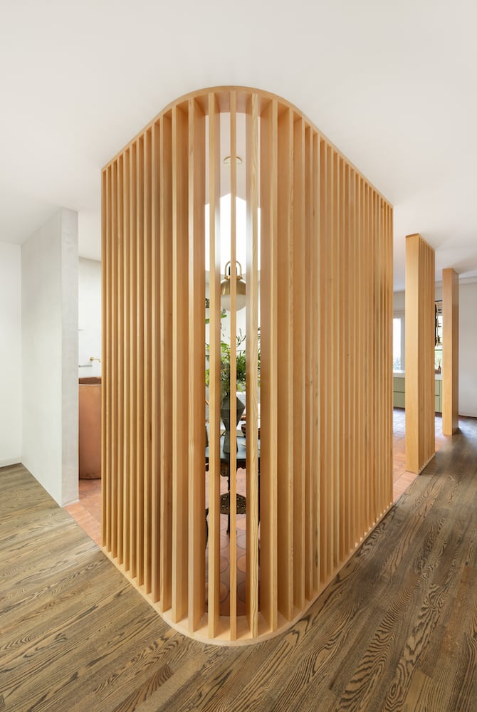 Expertly constructed wood slats curve 45 degrees allowing skylight to bask home