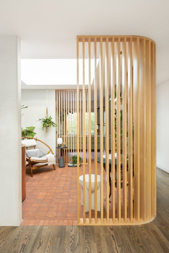 Wood slats allows light and style to flow amongst themselves in this midcentury reno