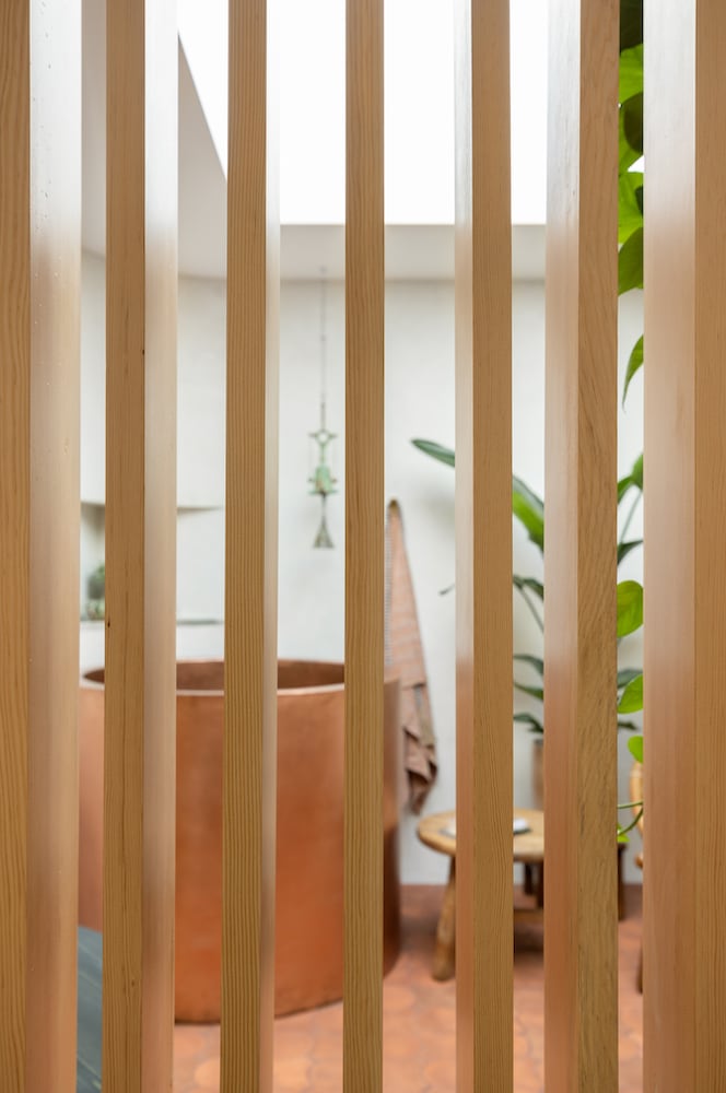 Detail of vertical wood breezeway slats in this kitchen/bathroom/atrium remodel