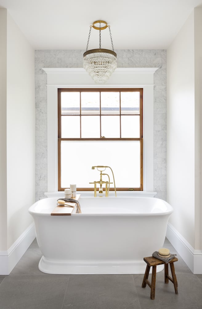 Bethany tub with gold bathing fixture, craftsman window, wallpaper, chandelier