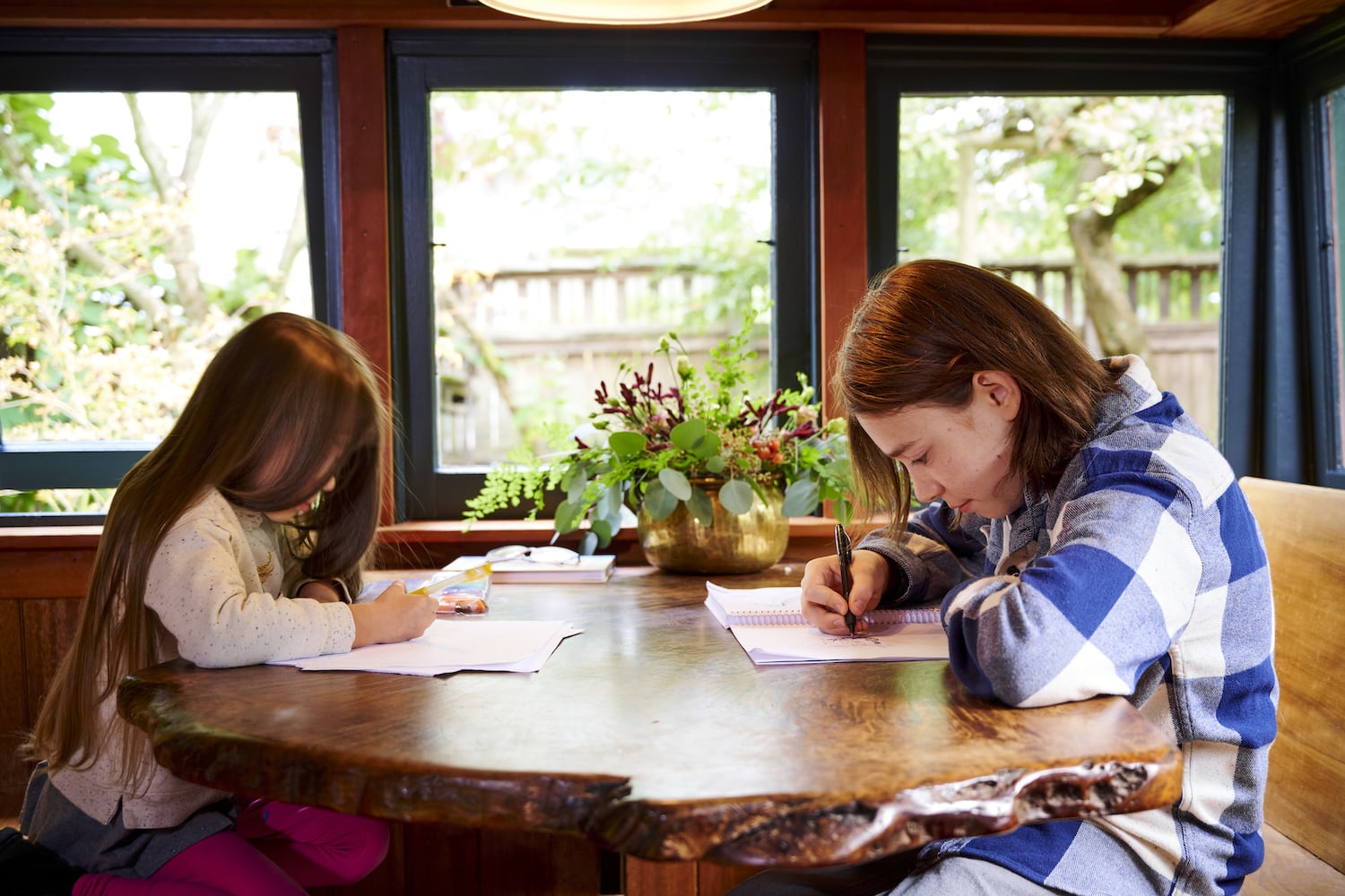 Children sit and draw at a creative live edge kitchen nook countertop table
