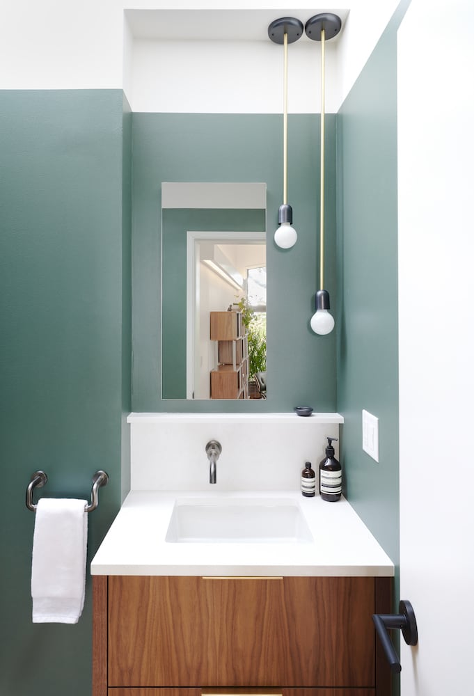 Bathroom with green walls, hanging mini pendant wall mount fixtures