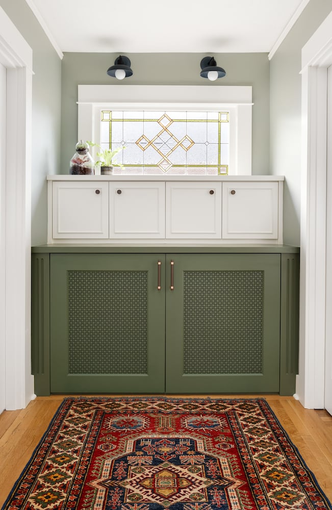 Green painted cabinets under white painted cabinets, stained glass window