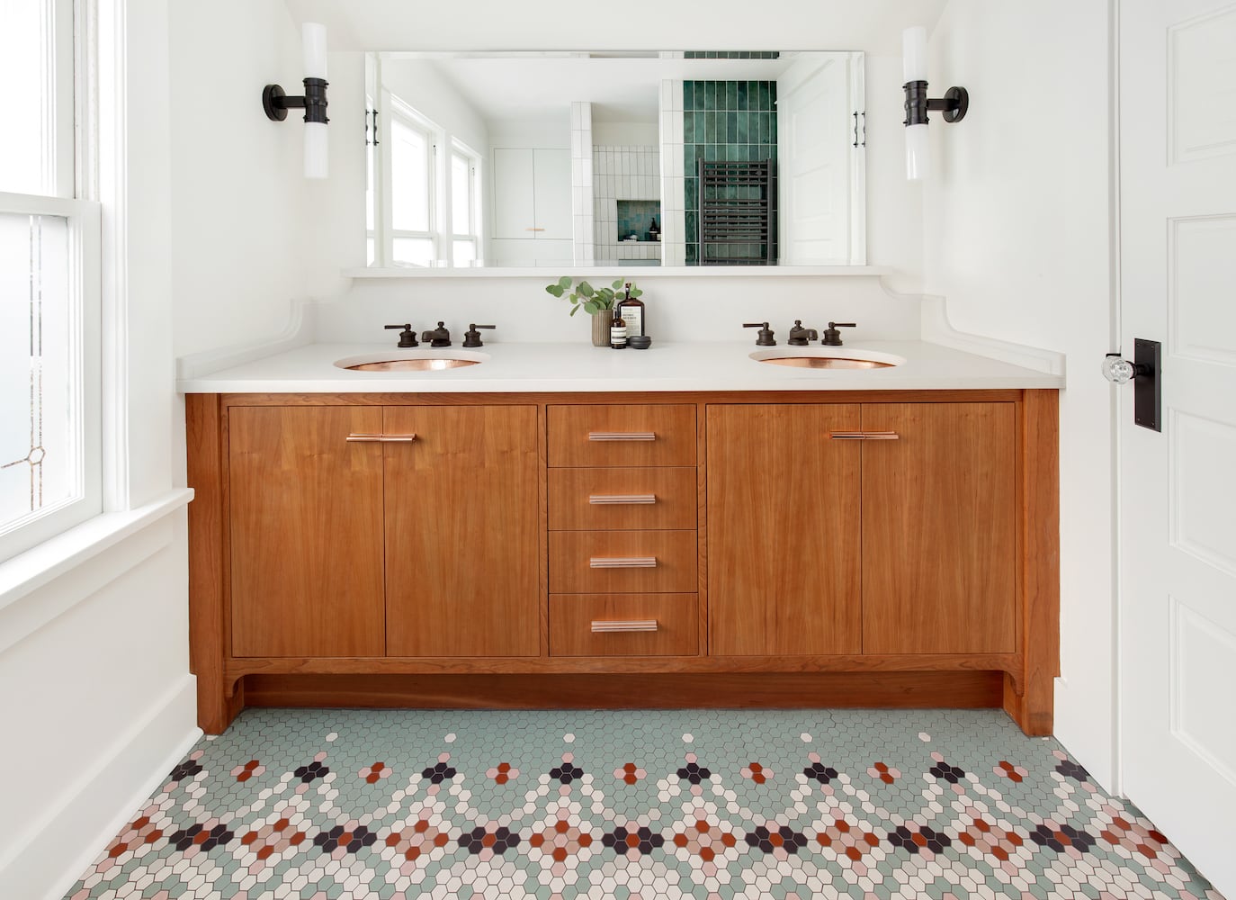 Primary bathroom vanity with cherry cabinets, pattern hexagon mosaic tile floor