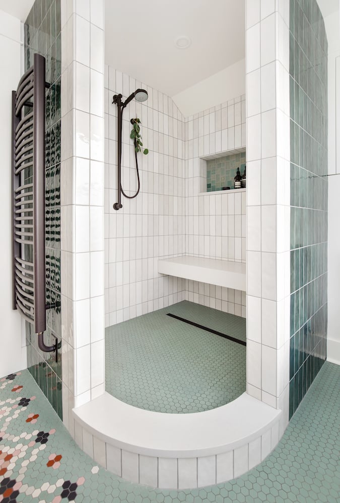 Walk in shower, curved curb, corner entry, green and white tile, towel warmer