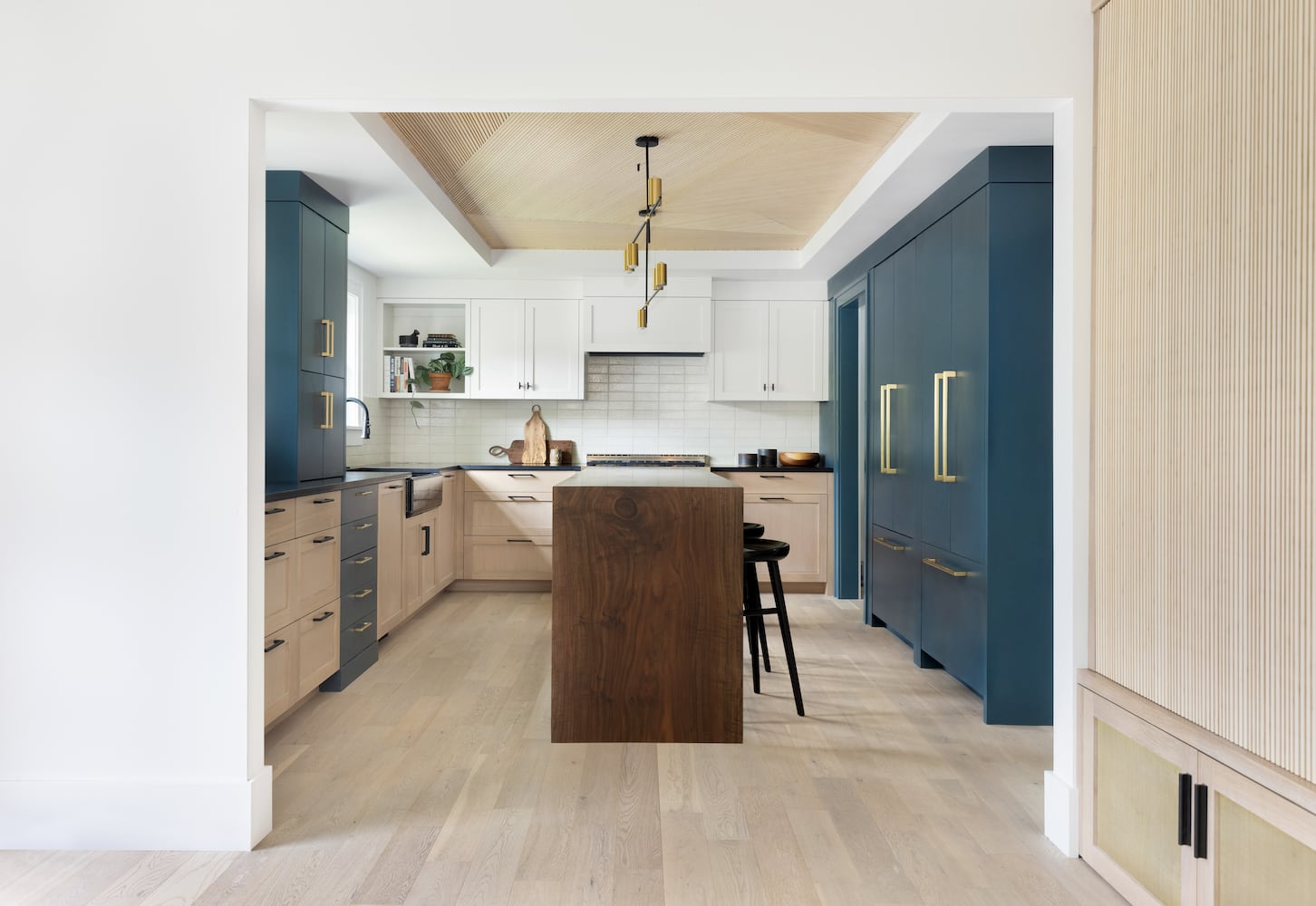 Custom Portland kitchen remodel with walnut waterfall island and geometric wood ceiling