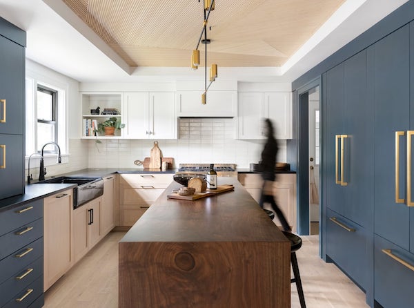 Redesigned Portland kitchen with black apron sink, blue cabinetry, walnut island